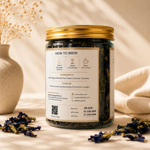 Tea jar with label and butterfly pea flowers on a neutral background
