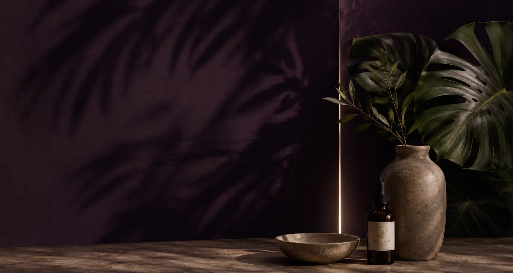 Decorative setting with a vase, bowl, and bottle against a dark purple background