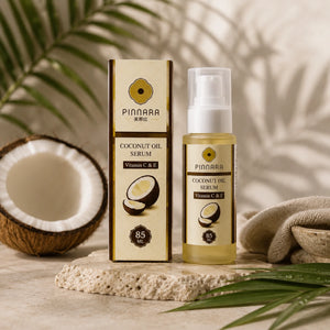 Pinnara coconut oil serum with packaging and a coconut on a natural background